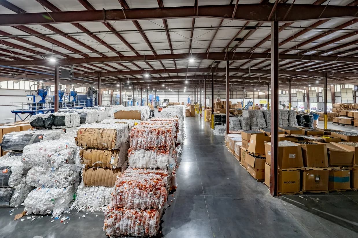 Plastic scrap bales staged in a warehouse for circular processing